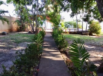 Garden area with palm trees, deck overlooking ocean on Coronado beachfront property