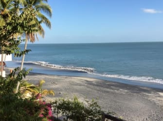 Scenic view of sandy beachfront, palm trees and ocean in Coronado development lot Panama