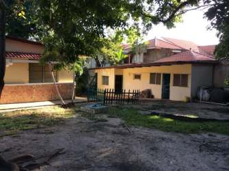 Existing house with red tiled roof on development land beachfront Coronado Panama