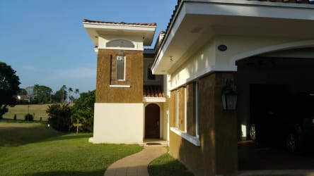 Kitchen with black granite counters, wood cabinets, and modern appliances in Tucán Golf Panama