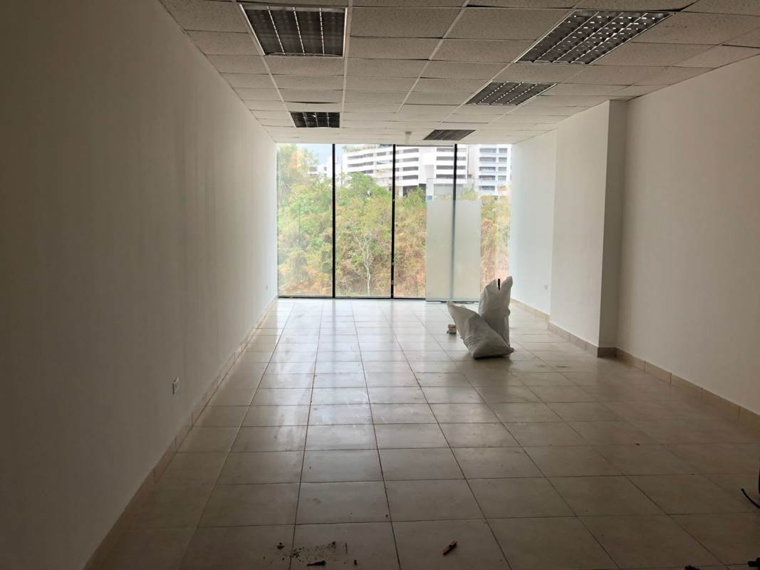 Well-lit office with large windows and neutral tiled flooring at Century Tower Panama