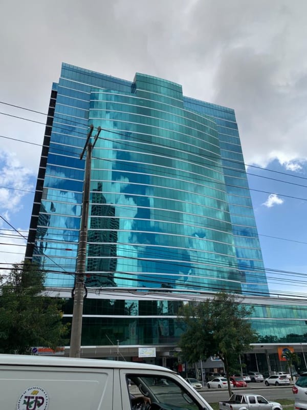 Glass office tower facade with reflective windows in Tumba Muerto Panama City