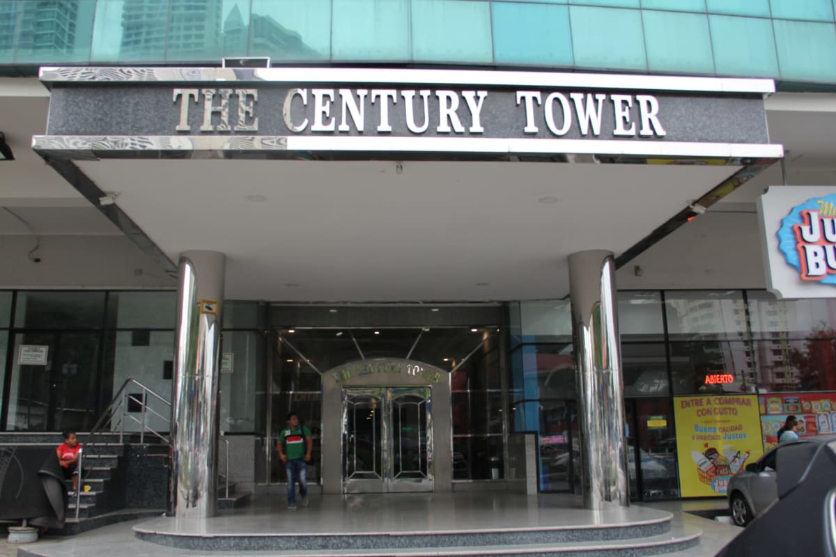 Main entrance canopy with metallic columns revolving glass door at Century Tower Panama City Panama