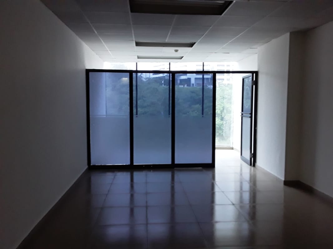 Modern office interior with glass dividers, tiled floors in Century Tower Panama