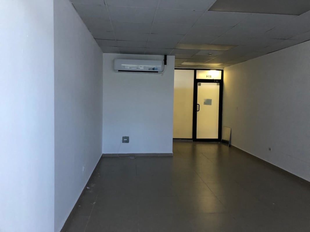 Empty office with tiled floor, drop ceiling, AC, glass entry door in Century Tower Panama