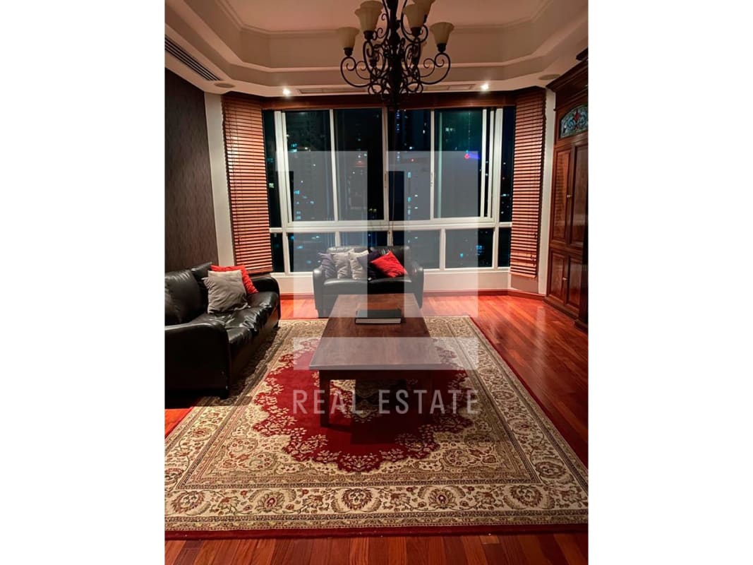 Luxurious living room with black sofa marble floors skyline views in PH Bahia Esmeralda Marbella Panama