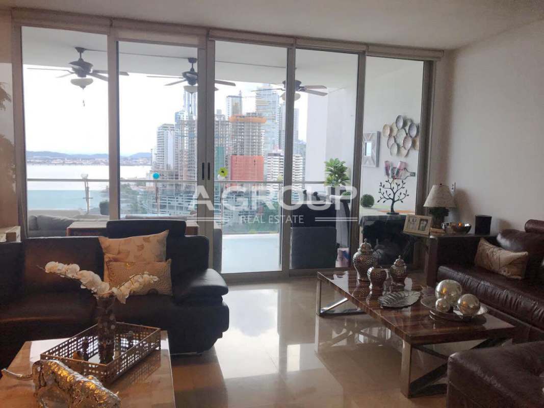 Comfortable family room with floor-to-ceiling windows ocean skyline view Aqualina Panama City