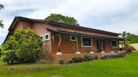 Traditional style entrance with blue exterior walls and clay tile roof at Hacienda Las Lagartijas Panama