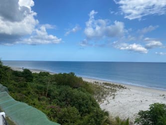 Resort-style swimming pool with heated jacuzzi overlooking Pacific Ocean