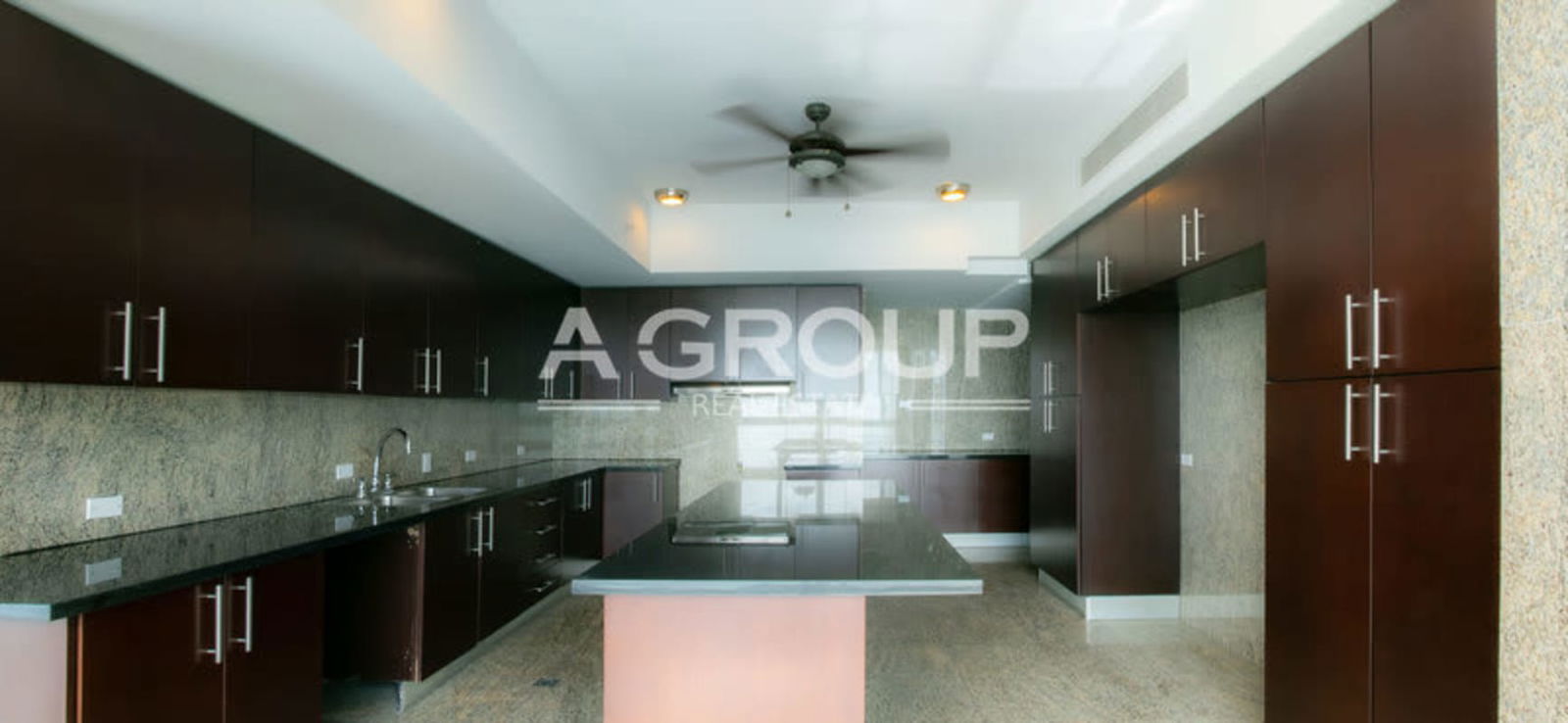 Modern upscale kitchen with granite countertops dark cabinetry The Point Punta Paitilla