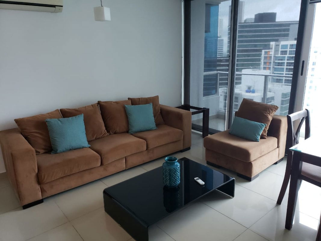 Bright living room with brown sofa city skyline view floor to ceiling windows PH Top Towers Costa del Este Panama