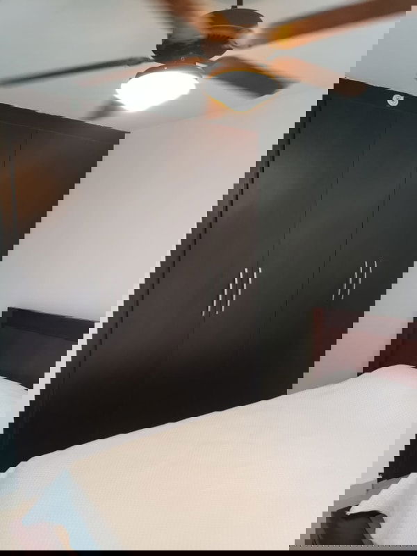 Bedroom with dark brown wardrobe ceiling fan minimalist design PH Top Towers Costa del Este Panama