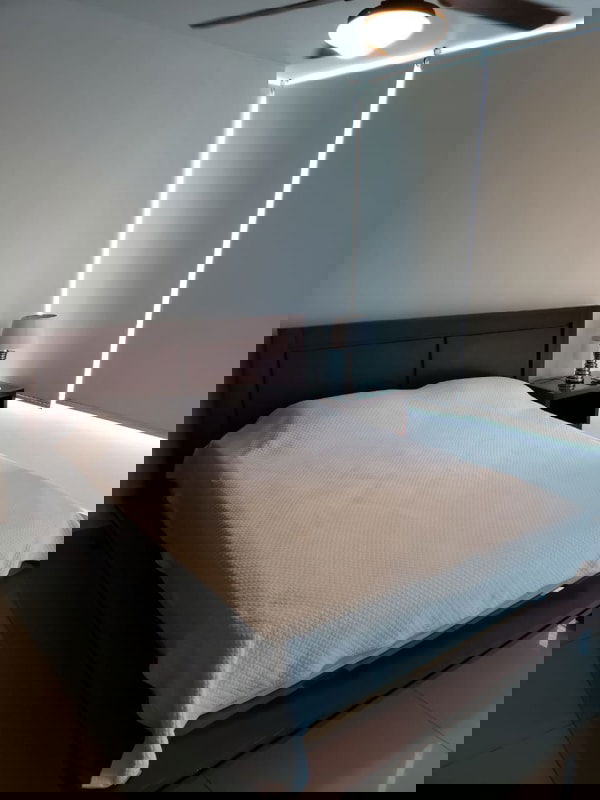 Minimalist bedroom with bed white linens built-in wardrobe Costa del Este PH Top Towers Panama