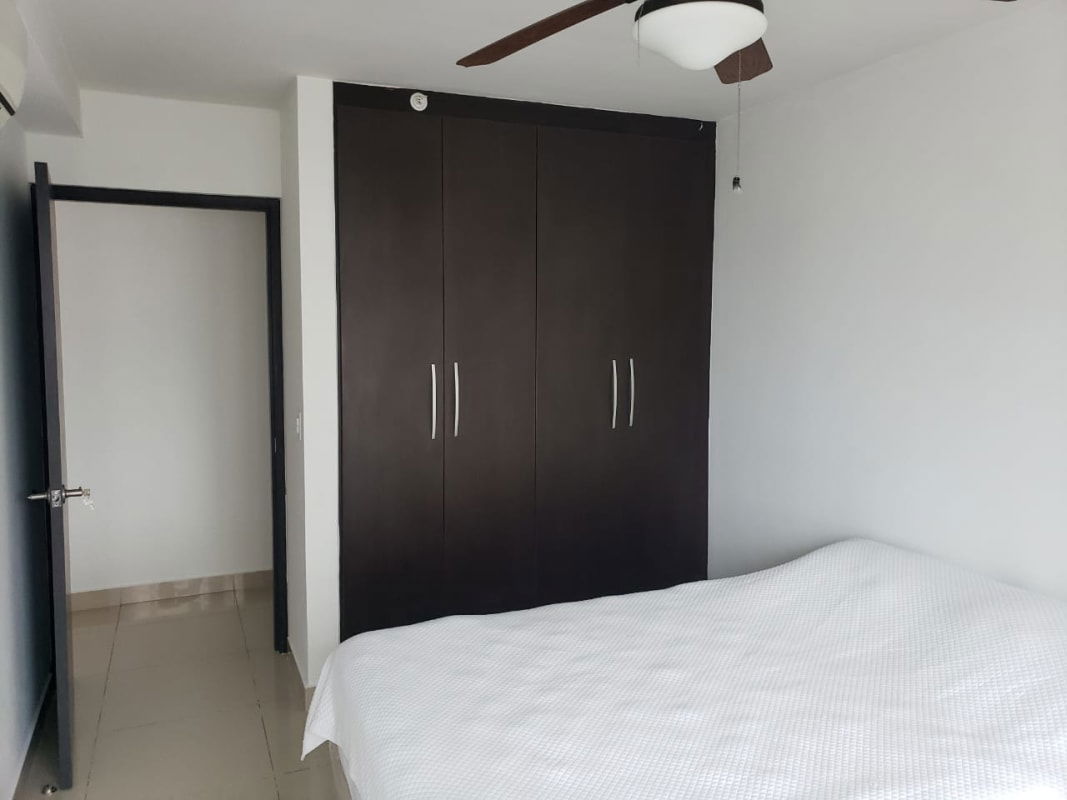 Contemporary bedroom with dark wardrobe tile floors ceiling fan Costa del Este PH Top Towers