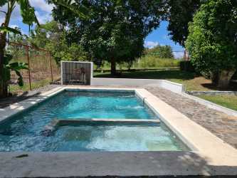 Bright rustic kitchen with white cabinetry and large window Nueva Gorgona Panama