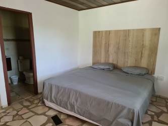 Large covered terrace and lush green garden at beachside Nueva Gorgona house Panama