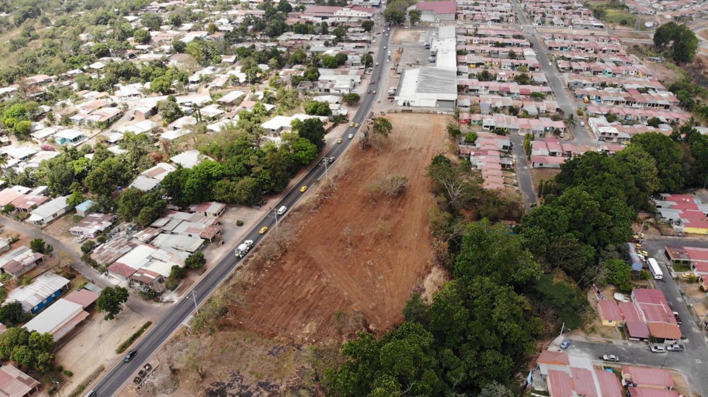 Vacant plot bordered by housing and major roadway in growing Pacora corridor Panama