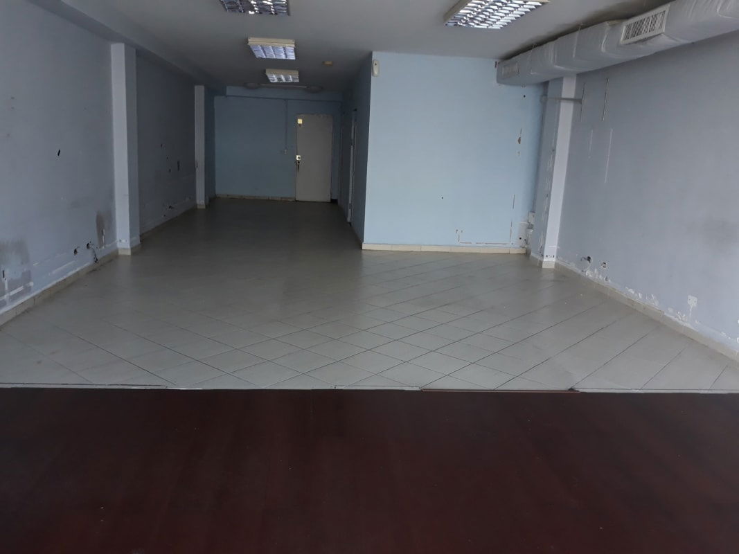 Empty commercial office space blue walls ceramic tiles fluorescent lights in PH Royal Park Panama City