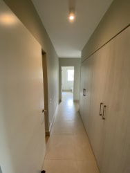 Modern spacious bathroom with double sinks and walk-in shower in beachfront apartment at Casamar Panama