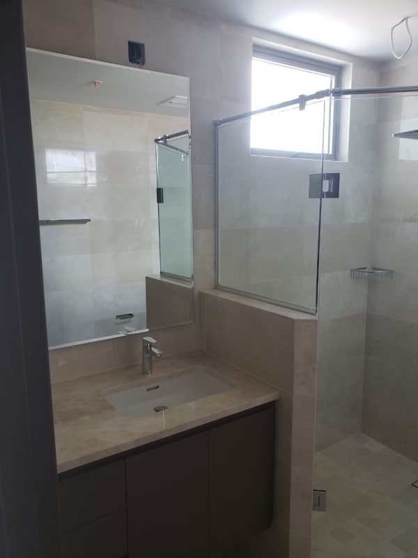 Modern double vanity bathroom with glass shower PH Green Garden Santa María Panama