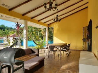 Bedroom with twin beds, AC unit, bright windows in Club Ecuestre Coronado Panama