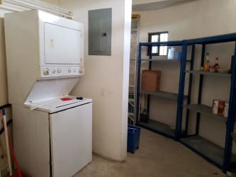 Laundry room with washer dryer and storage shelves Club Ecuestre Coronado Panama