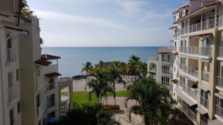 Bright living room with blue decor, sofa beds and balcony view in beachfront apartment Puntarena Buenaventura Panama