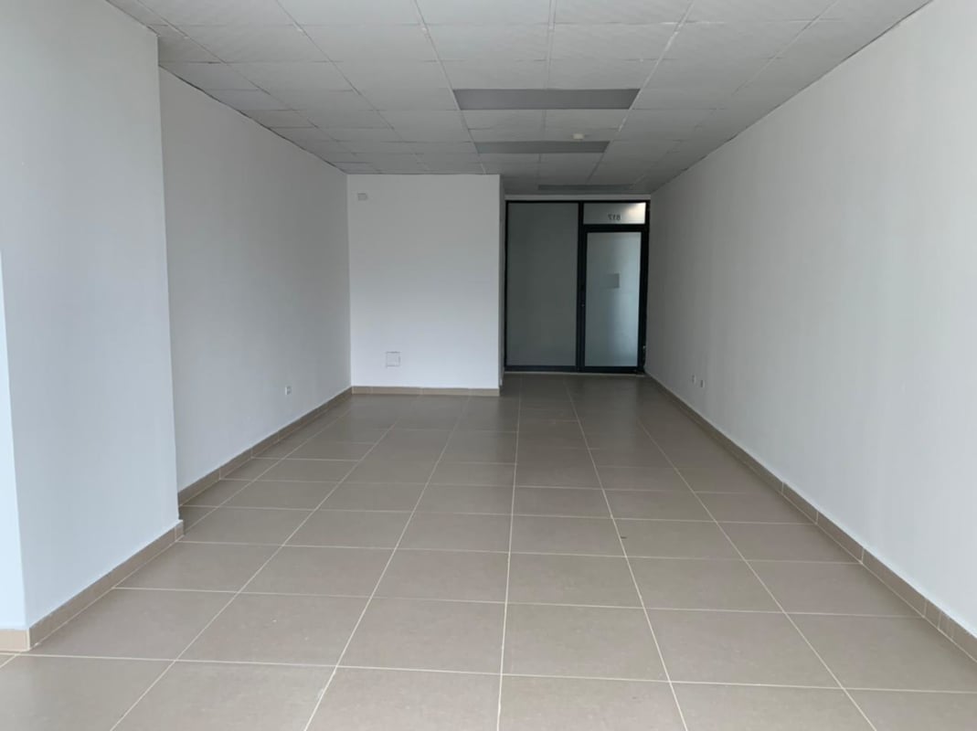 Bright empty office with white walls, tiled floors, frosted glass door located in The Century Tower Panama