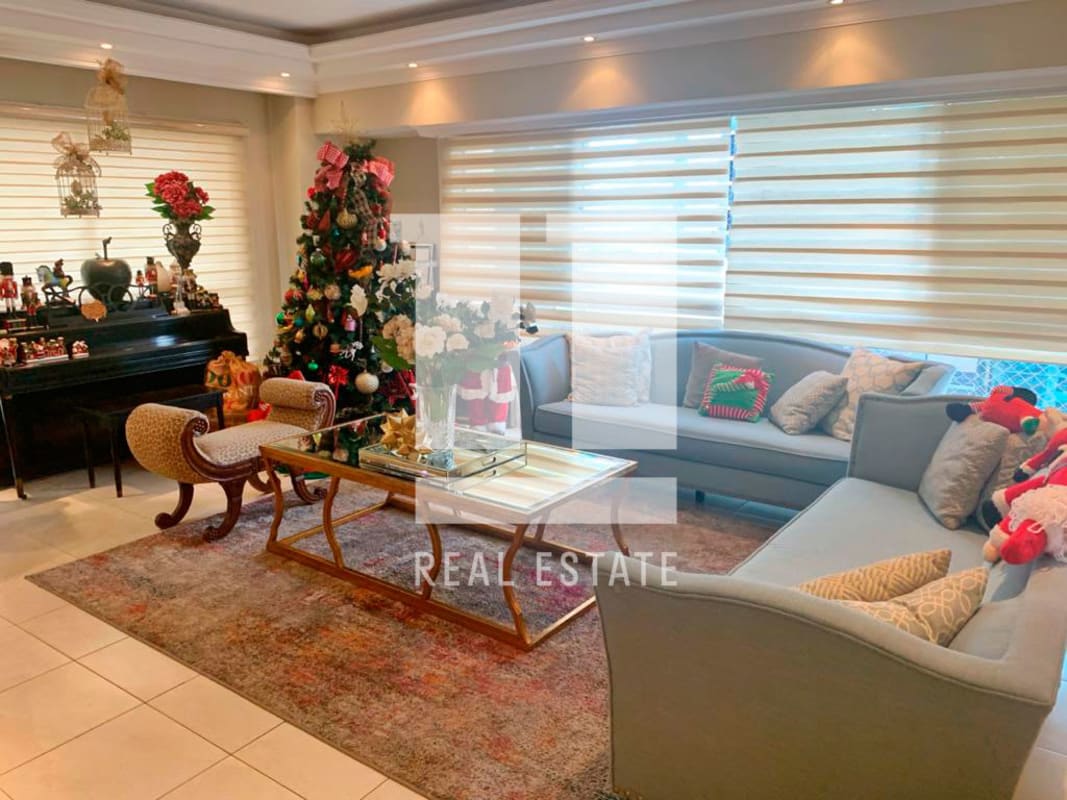 Large elegant living and dining space with lighting fixtures and panoramic windows in PH Victoria Tower Obarrio