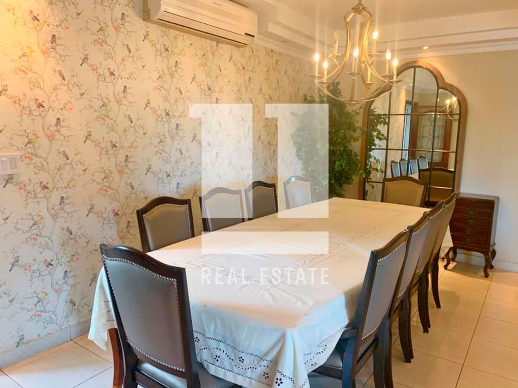 Formal dining room with chandelier and artwork in PH Victoria Tower Obarrio