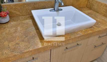 Modern kitchen with island, open floor plan dining room in Casamar beachfront villa Panama