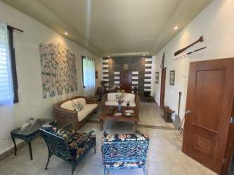 Modern bathroom with tiled walls, walk-in shower, and toilet in San Carlos house