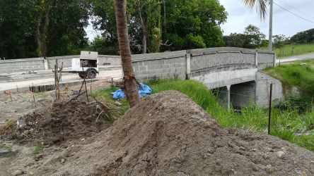 Concrete bridge construction over small waterway at Villas Campestres project Panama
