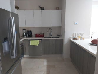 Modern kitchen with white and gray cabinetry and stainless appliances Puntarena Buenaventura Panama