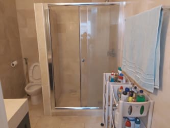 Contemporary bathroom with glass shower enclosure, tile walls in Puntarena apartment Buenaventura Panama