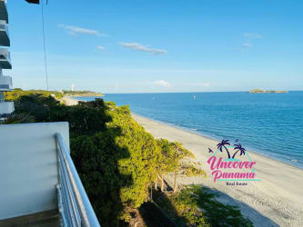 Open living room with large sliding doors to balcony overlooking Pacific Ocean in Farallón Panama