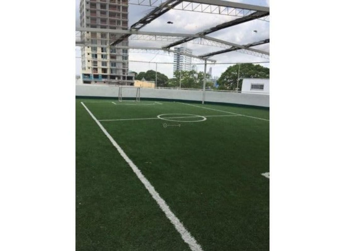 Rooftop playground with slide, artificial turf and play structures PH Splendor By The Park Panama City