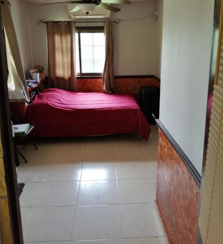 Kids room with playful mural art, tiled floor and bright colors in house for sale Panama