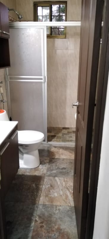 Functional laundry area with washer hookup, storage and natural light in Panama City residence