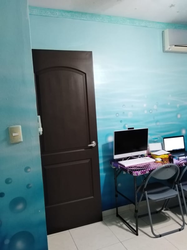 Tile staircase with wrought iron railing and bathroom under stairs in Las Acacias residence