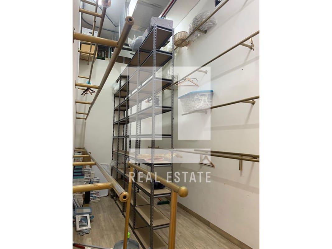 Interior boutique retail space with clothing display racks wood floors Atrio Mall Panama City