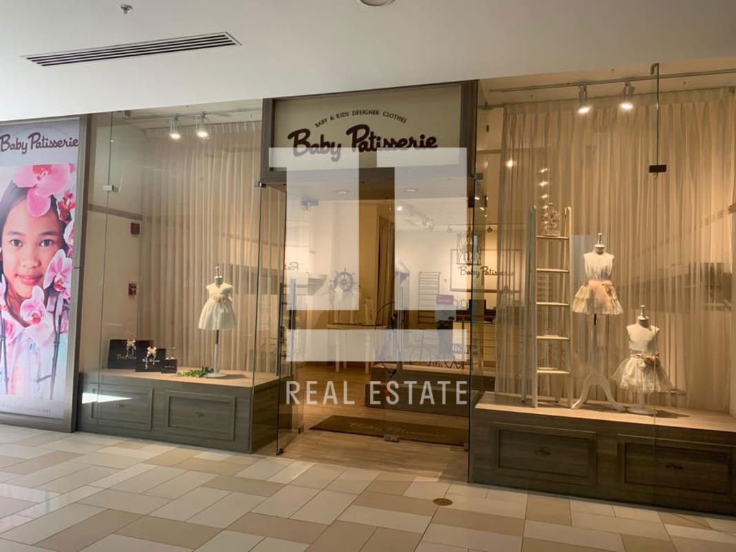 Multi-level shopping mall interior with escalators and boutiques in Atrio Mall Costa del Este Panama City