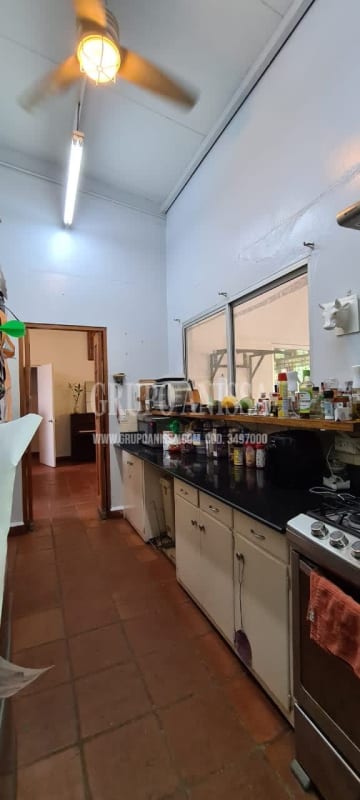Traditional kitchen with open shelves ceiling fan tile floors Diablo Heights home