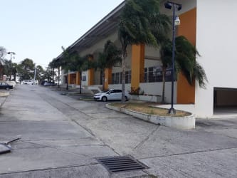 Warehouse building with parking spaces and palm trees at PH Coronado Plaza Panama
