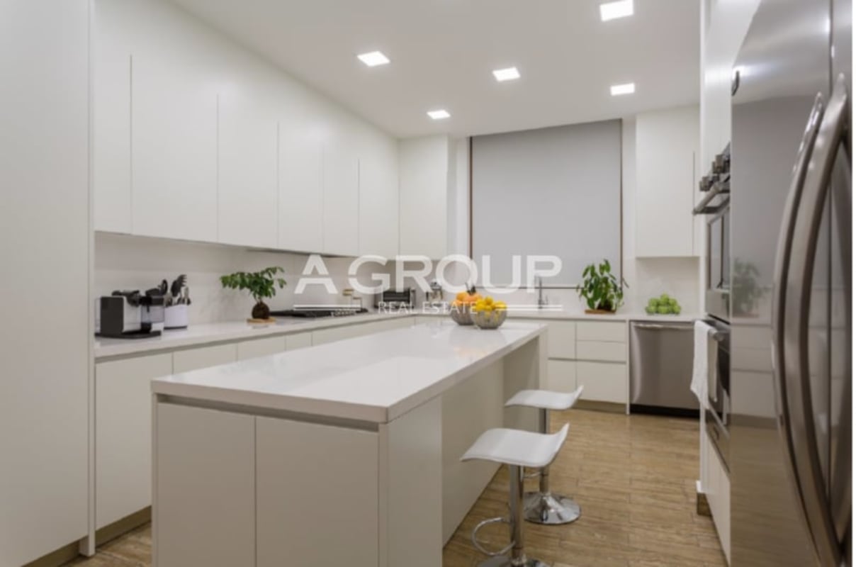 Spacious modern kitchen with island and appliances in Ocean Reef Islands luxury condo
