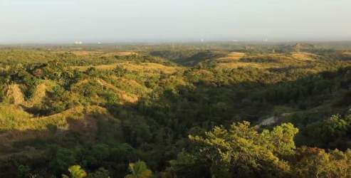 Wide countryside land parcel with distant hills and blue skies perfect for projects in Panama