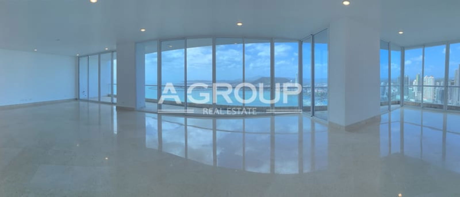 Modern living room with floor-to-ceiling windows, panoramic ocean view at The Point Panama City