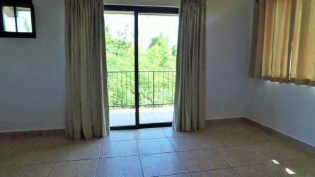 Spacious master bedroom with high ceilings, walk-in closet, balcony access overlooking the mountains in Altos del Maria Panama