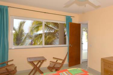 Beachfront villa exterior surrounded by palms and Pacific Ocean in Veracruz Panama