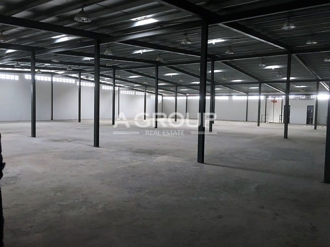 Interior view of warehouse steel support beams concrete floor and high roof Llano Bonito Panama